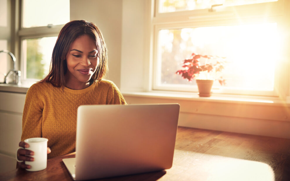 Laughing woman looking at laptop