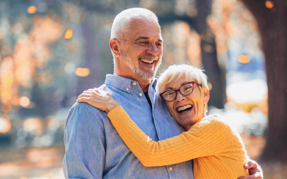 Active seniors on a walk in autumn forest