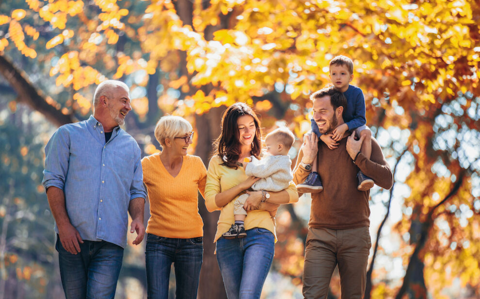 Multl generation family in autumn park having fun ilit