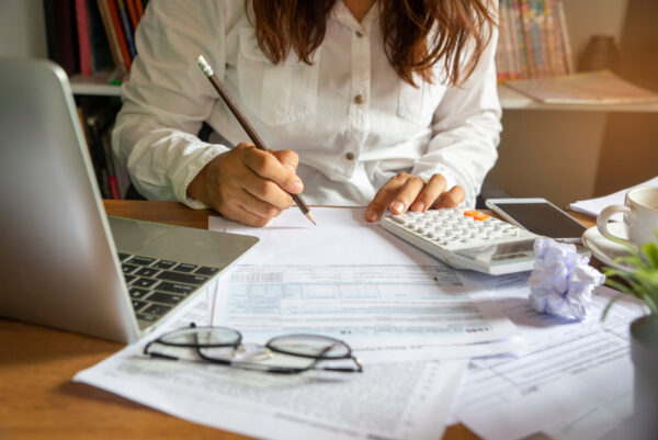 Budget planning concept, Accountant is calculating company’s annual tax. Calendar 2024 and personal income tax forms for those who have income under US law placed on office desk marginal income tax brackets