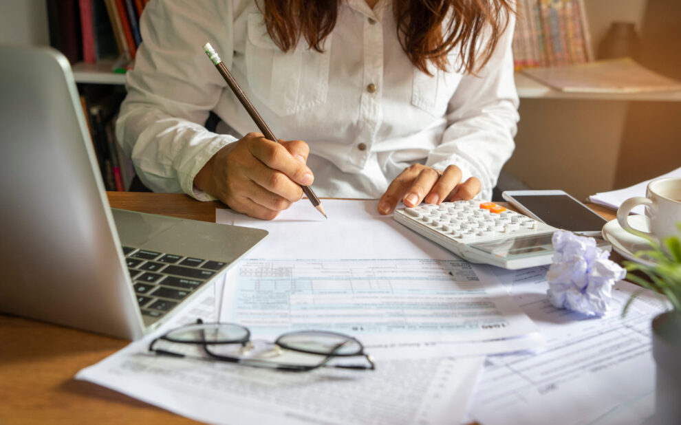 Budget planning concept, Accountant is calculating company’s annual tax. Calendar 2024 and personal income tax forms for those who have income under US law placed on office desk marginal income tax brackets