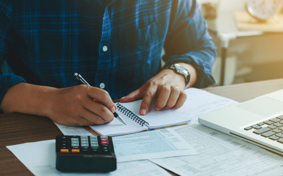 Man doing finances and calculate about cost to real estate inves