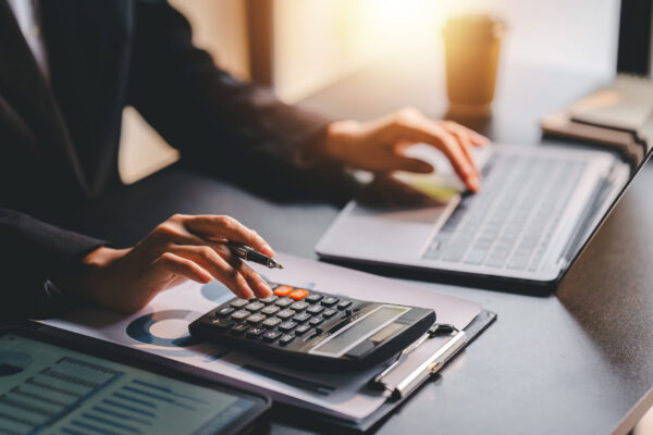 Portrait of a woman working on a tablet computer in a modern off capital gains and losses