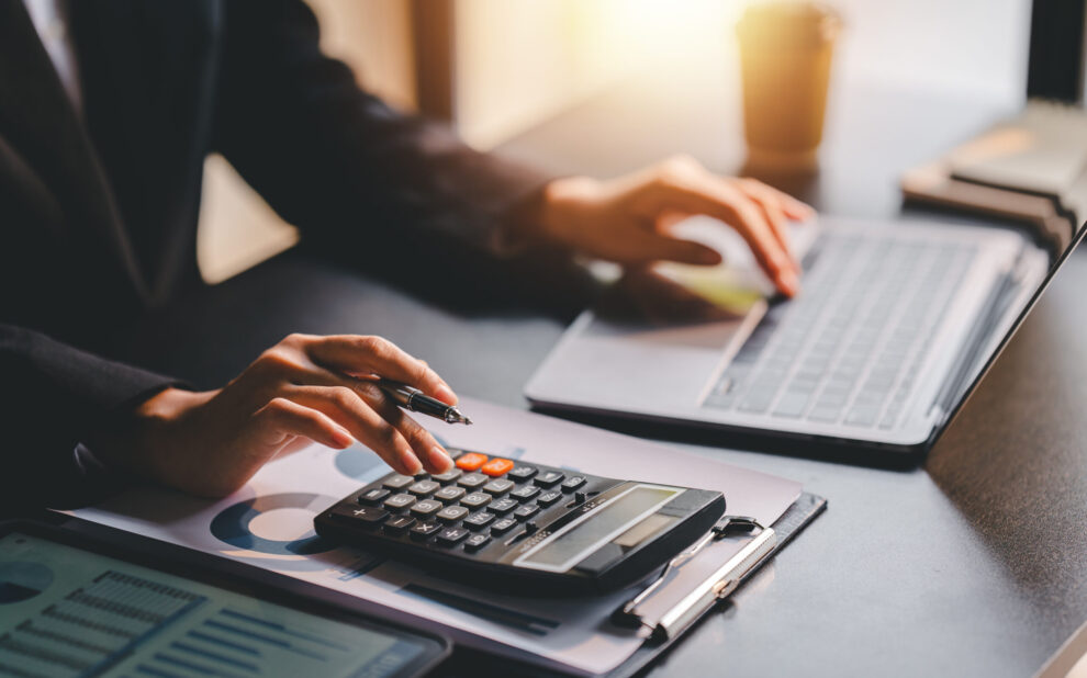 Portrait of a woman working on a tablet computer in a modern off capital gains and losses