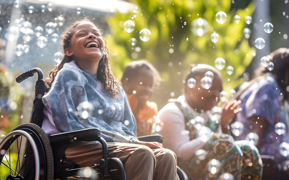 A Happy smiling Girl sitting in a Wheelchair. Children disabled person. Inclusive Education Concept. child with special needs,