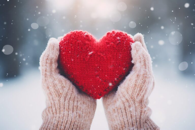 Hands holding a red heart with wooden mittens. Generative ai. year-end charitable giving year end charitable giving