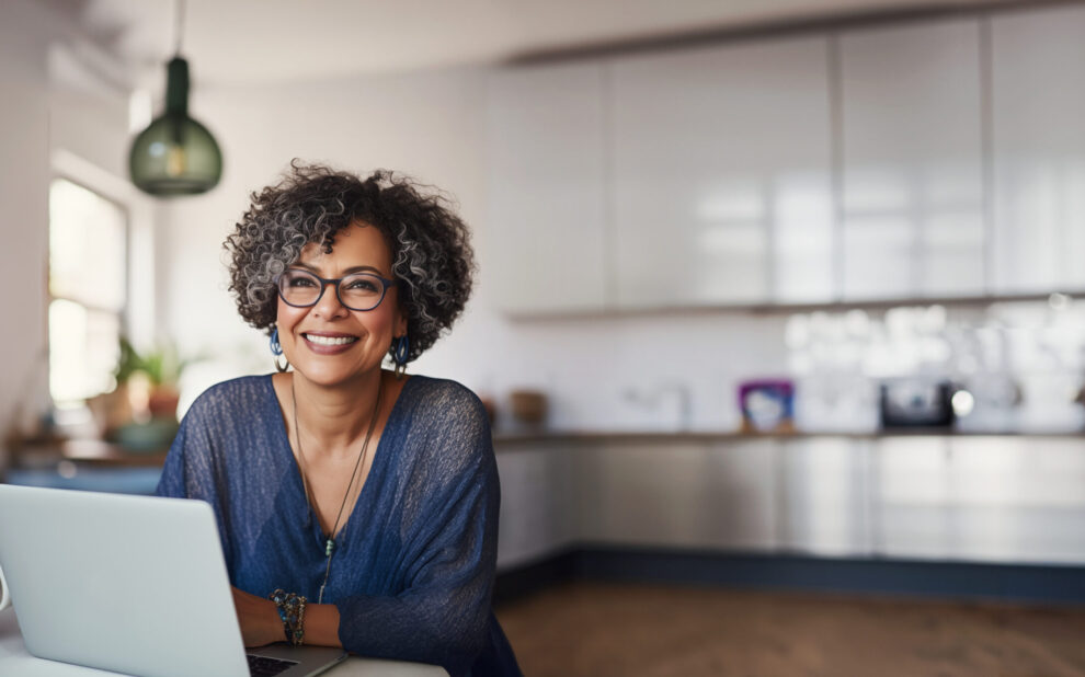 Middle Aged Woman Working from Home in her modern Kitchen women and retirement